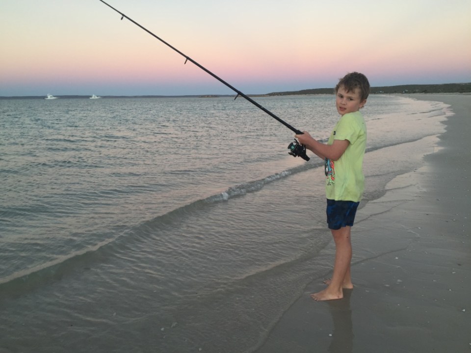 Aaron fishing off our beach.