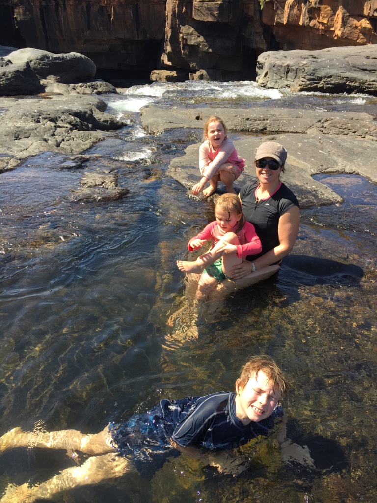Playing in the waterfall at Mitchell top pools