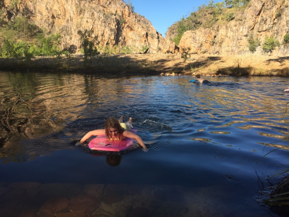 Riding boogie boards over to the lower falls 